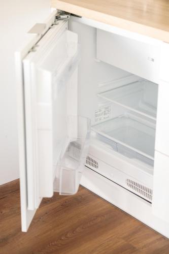 an empty refrigerator with its door open at Baltic Apartments in Pobierowo