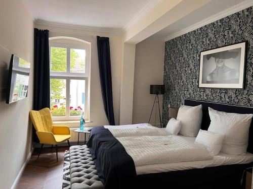 a bedroom with a large bed and a window at Schlosshotel Rheinsberg in Rheinsberg