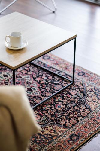a coffee table with a coffee cup on top of a rug at Baltic Apartments in Pobierowo