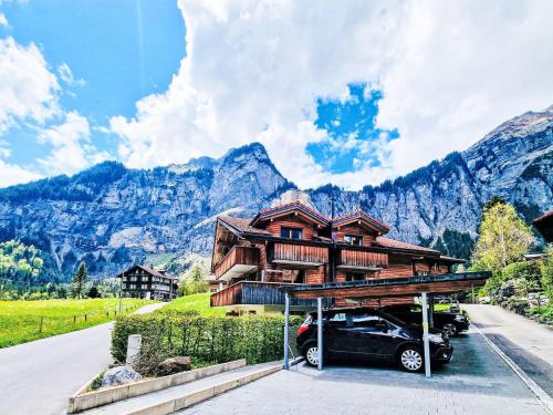 a house with a car parked in front of it at Apartment Bergluft by Interhome in Kandersteg