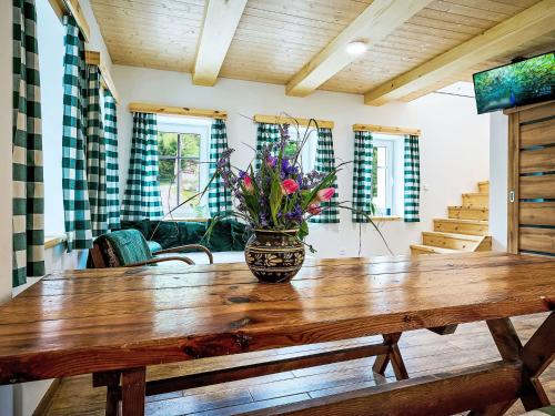 a vase of flowers sitting on a wooden table at Holiday Home JaZ by Interhome in Bedřichov