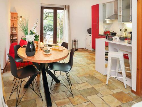 a kitchen and dining room with a table and chairs at Apartment Le 55Cici by Interhome in Bouveret