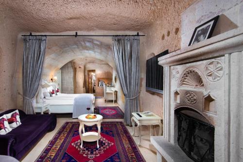 a living room with a couch and a fireplace at Vigor Cappadocia - Special Class in Uchisar