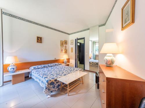 a bedroom with a bed and a desk at Apartment Il Veliero by Interhome in Punta Ala