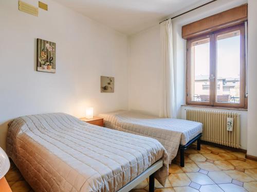 a bedroom with two beds and a window at Apartment Fruet by Interhome in Pergine Valsugana