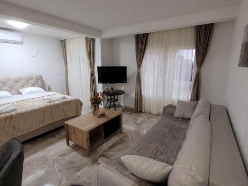 a living room with a bed and a couch at Montenegro Apartments Phoenix With Pool in Bar