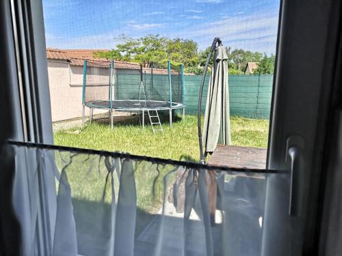 a view from a window of a patio with a table at Levendula Apartman in Makó