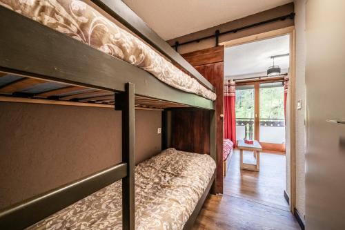 two bunk beds in a room with a hallway at Les Avenières in Châtel