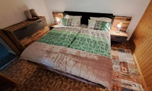 a bedroom with a large bed with two night stands at Ristorante della Posta Carena in Carena