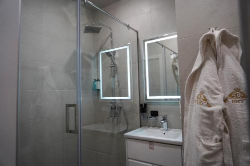 a bathroom with a shower and a sink at Igit Plaza Hotel in Gyumri