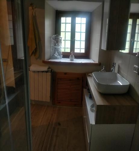 a bathroom with a sink and a window at Casa vacanze Abetone in Pianosinatico