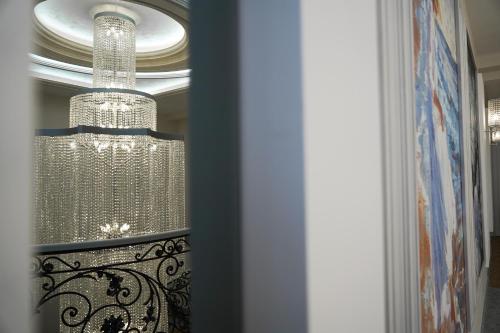 a chandelier is hanging from a ceiling at Igit Plaza Hotel in Gyumri