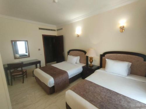 מיטה או מיטות בחדר ב-Palma Di Sharm Hollywood Aqua Park Resort