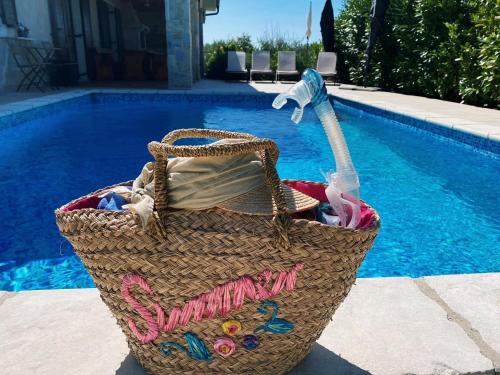 a picnic basket sitting next to a swimming pool at Villa Seaside in Krk
