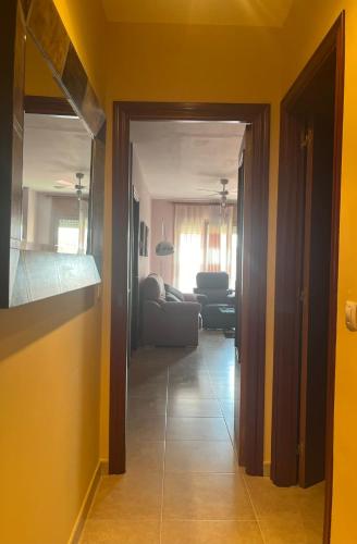 a hallway leading to a living room with yellow walls at Apartamento Pilarín in Alcañiz