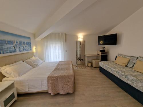 a bedroom with a large bed and a couch at Hotel Villa Anthea in Garda