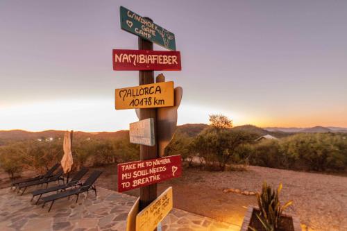 a pole with street signs on it in the desert at Windhoek Game Camp in Lafrenz Township