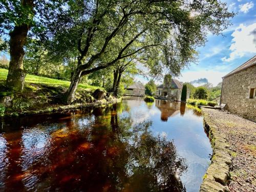 a river with trees on the side of it at Moulin du Gast 35pers : jacuzzi sauna billard baby in Le Gast