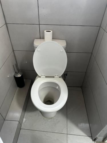 a bathroom with a toilet with a roll of toilet paper on it at RANTI Guest House in Ga-Mothiba