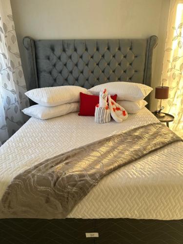 a bed with two stuffed animals sitting on it at RANTI Guest House in Ga-Mothiba