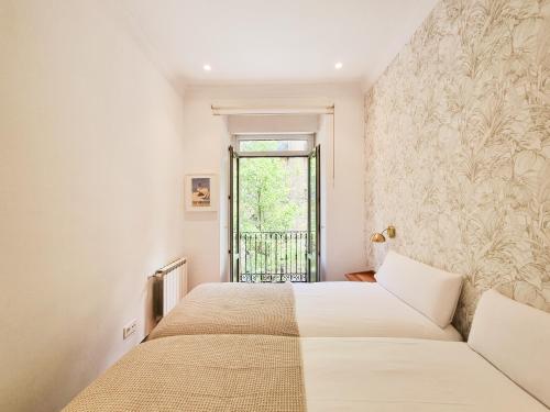 a bedroom with two beds and a window at Costa Getaria - Iberorent Apartments in San Sebastián