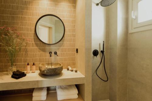 a bathroom with a sink and a mirror at Opal Paros in Naousa