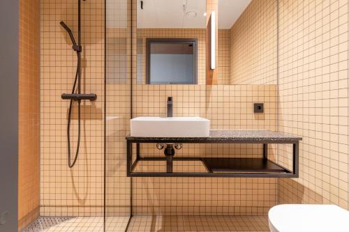 a bathroom with a sink and a shower at Comfort Hotel Helsinki Airport in Vantaa