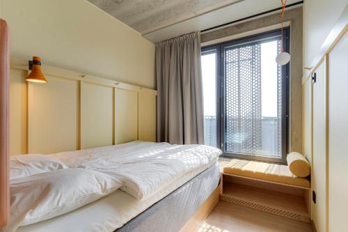a bedroom with a bed and a large window at Comfort Hotel Helsinki Airport in Vantaa