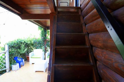 a wooden staircase leading up to a patio at Velipoja Private Chalet in Velipojë