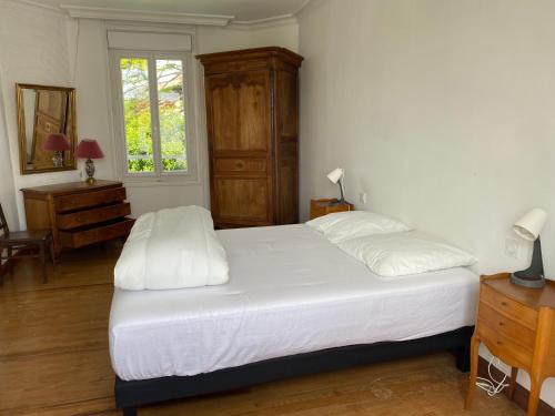 une chambre avec un grand lit blanc et une fenêtre dans l'établissement Élégante Villa centre ville Royan proche plages 3 chambres 3 grands lits, à Royan