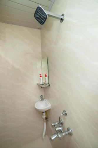 a bathroom with a sink and a mirror at Paradise Homestay - Lodging and Boarding in Pune