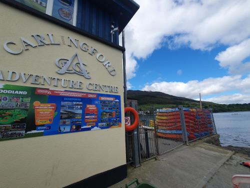 a sign for an adventure centre next to a body of water at The Retreat in Carlingford