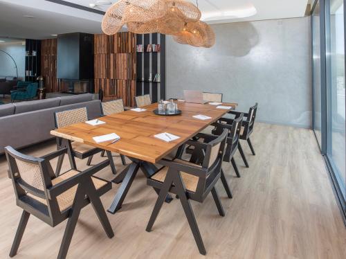 a wooden table and chairs in a room at Santa Cruz - Movement & Nature House in Santa Cruz