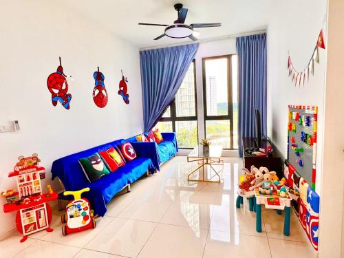 a living room with a blue couch and some toys at Legoland-Happy Wonder Love Suite-Elysia- Max8pax-with Garden-Pool view in Nusajaya
