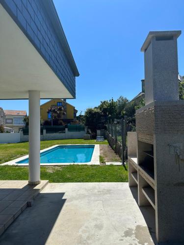 a swimming pool in the backyard of a house at Villa Paxariño in Vilagarcia de Arousa