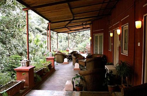 a porch of a house with couches and plants at Ranjit's Svaasa Amritsar in Amritsar