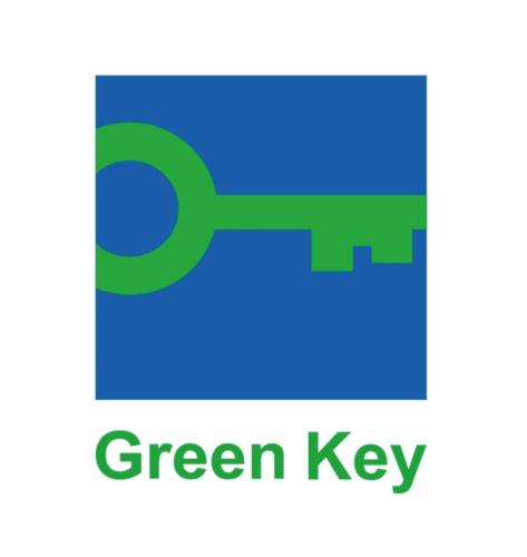 a green key sign in a blue and white at Corp Amman Hotel in Amman