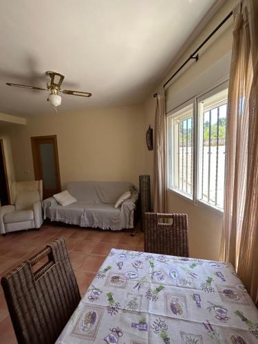 a living room with a bed and a table and chairs at Apartamento Casa Rafa in Navajas