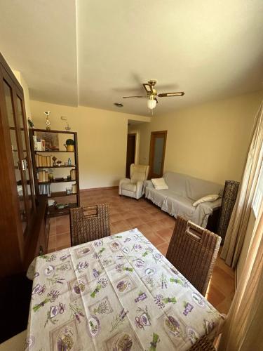 a dining room with a table and a couch at Apartamento Casa Rafa in Navajas