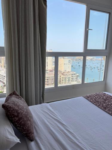 - une chambre avec un lit et une grande fenêtre dans l'établissement SEA VIEW PARADISE 2, à Alexandrie