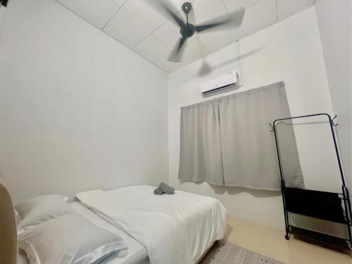 a white room with a bed and a ceiling fan at Quayside Cove Homestay - Corner House, Shah Alam Rimbayu Netflix Syok TV BBQ in Shah Alam