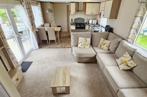 a living room with a couch and a table at 2 bed 2 ensuite Holiday Home in St Austell