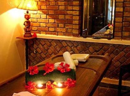 a sink with candles and flowers on top of it at Ranjit's Svaasa Amritsar in Amritsar