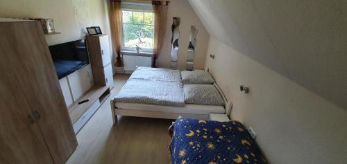 a small room with a bed and a couch at Ferienwohnung in der ersten Etage mit großer Dachterrasse - b48719 in Detern