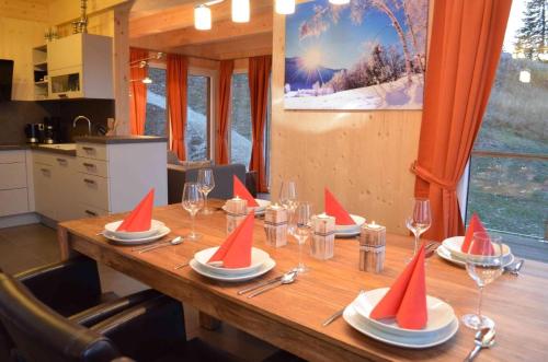 a wooden table with red party hats on top of it at Tolles Ferienhaus mit Sauna und Whirlpool in Wolfsberg