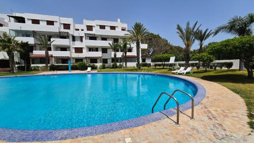 une grande piscine en face d'un bâtiment dans l'établissement Best Apartment La Cassia Beach & Golf Resort, Cabo Negro, à Cabo Negro