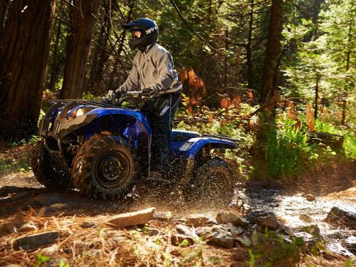 a man riding a atv in the woods at Deerhurst Resort in Huntsville
