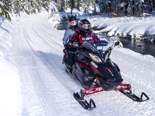 two people riding on a motorcycle in the snow at Deerhurst Resort in Huntsville