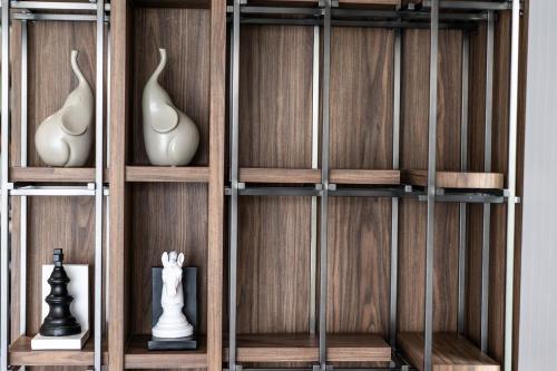 a wooden shelf with vases and vases on it at WE HOTEL RIVERFRONT in Bang Su