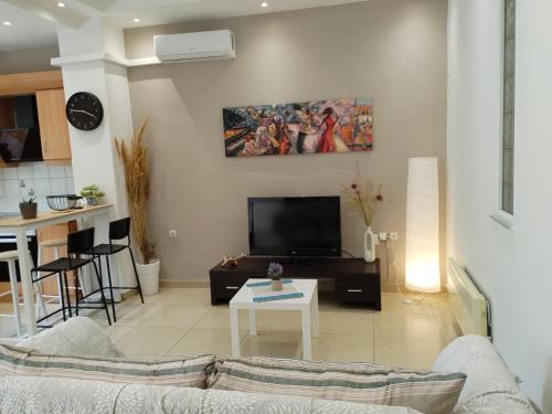 a living room with a couch and a table at Eunoia, Executive Residence, 34 Theofrastou str, Ground floor, 5min to the beach in Kos Town